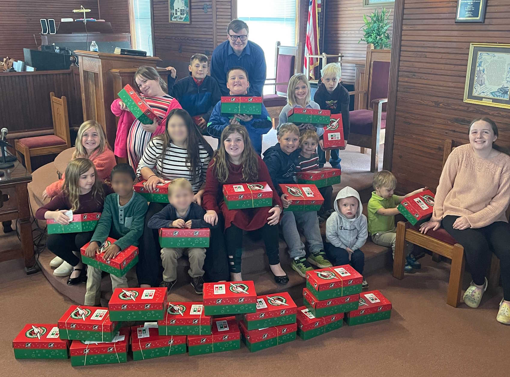 Children showing the Operation Christmas Child boxes they packed.